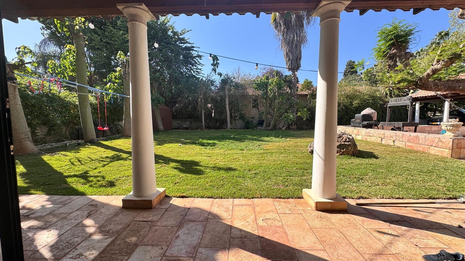 The open-air courtyard — a huge grass field framed by the colonnade