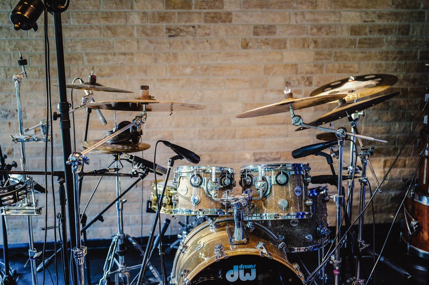 DW drum kit miked against a stone wall