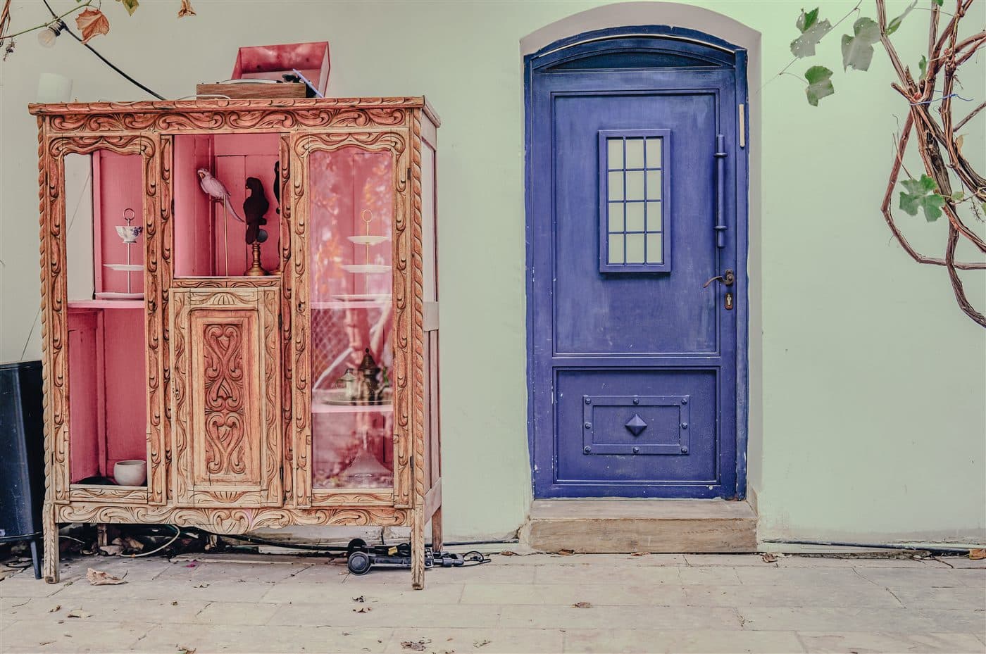 An ornate vintage cabinet beside the blue castle door