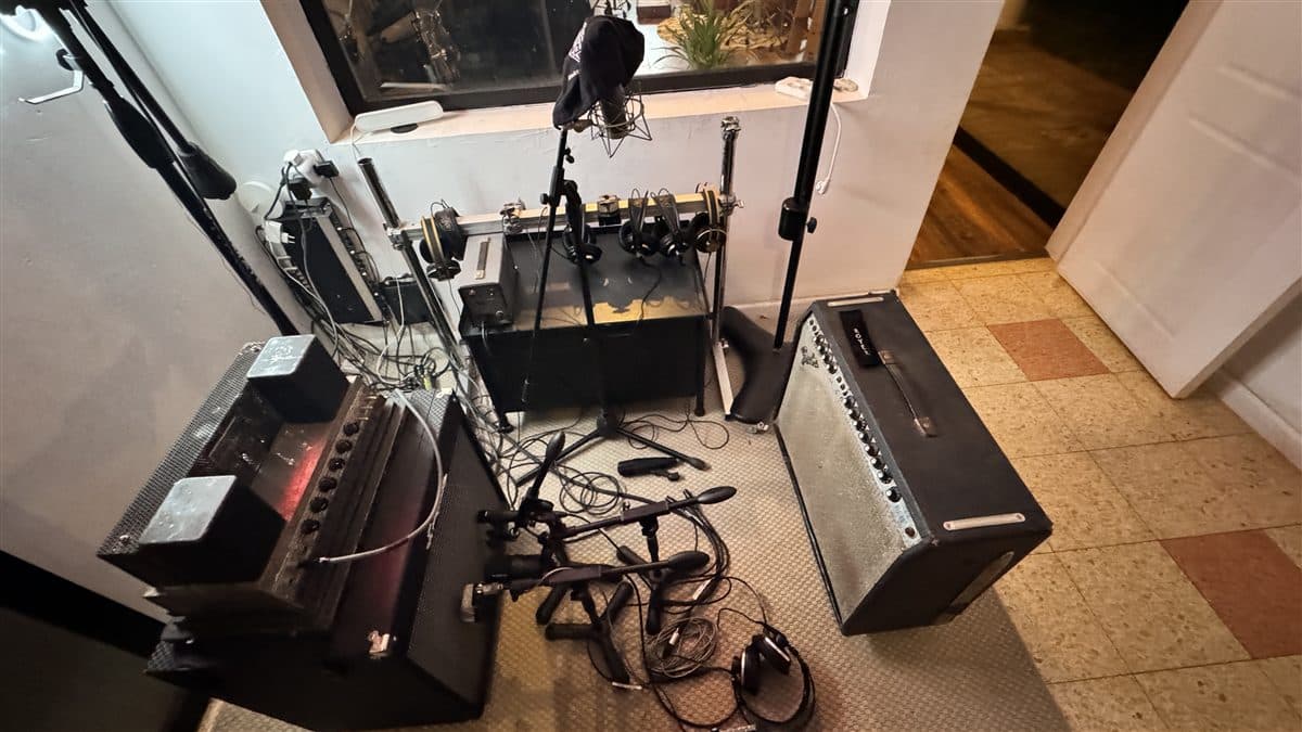 Guitar and bass amps set up in the iso booth