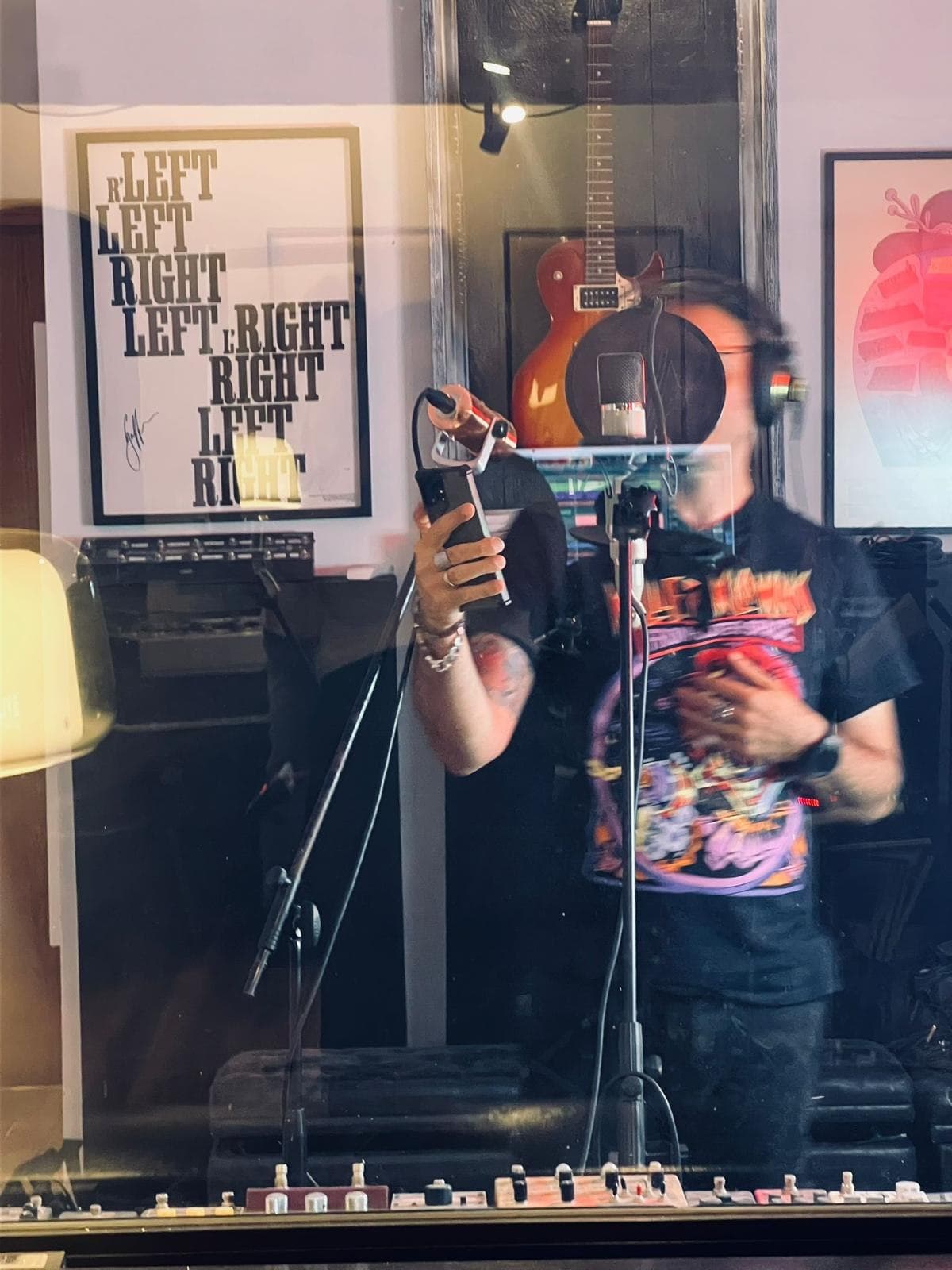 A vocalist tracking through the booth glass